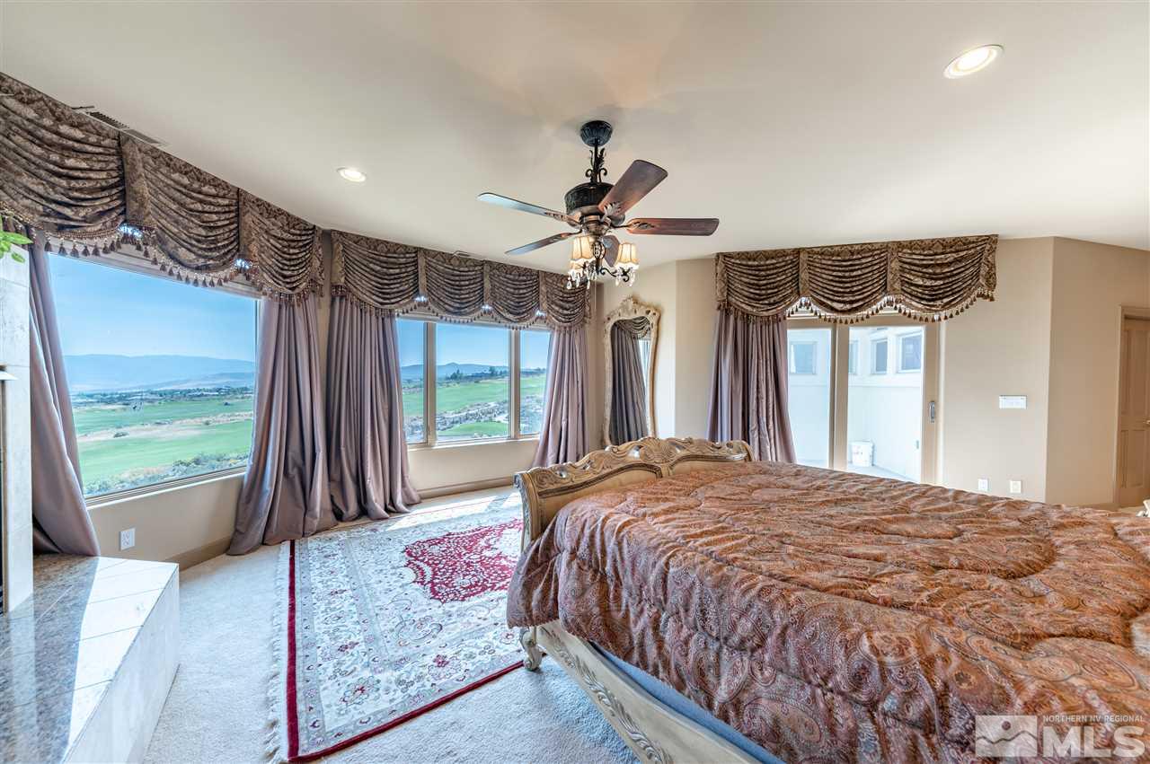 10055 Trailside Court Reno, NV 89511 - Photo 20 of 26 a bed sitting in a bedroom next to a window