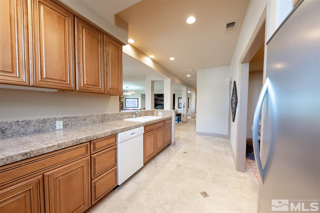 10055 Trailside Court Reno, NV 89511 - Photo 26 of 26 a large kitchen with stainless steel appliances granite countertop a refrigerator and a sink