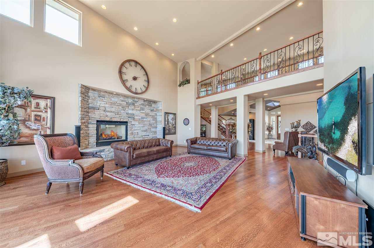 10055 Trailside Court Reno, NV 89511 - Photo 8 of 26 a living room with furniture a flat screen tv and a fireplace