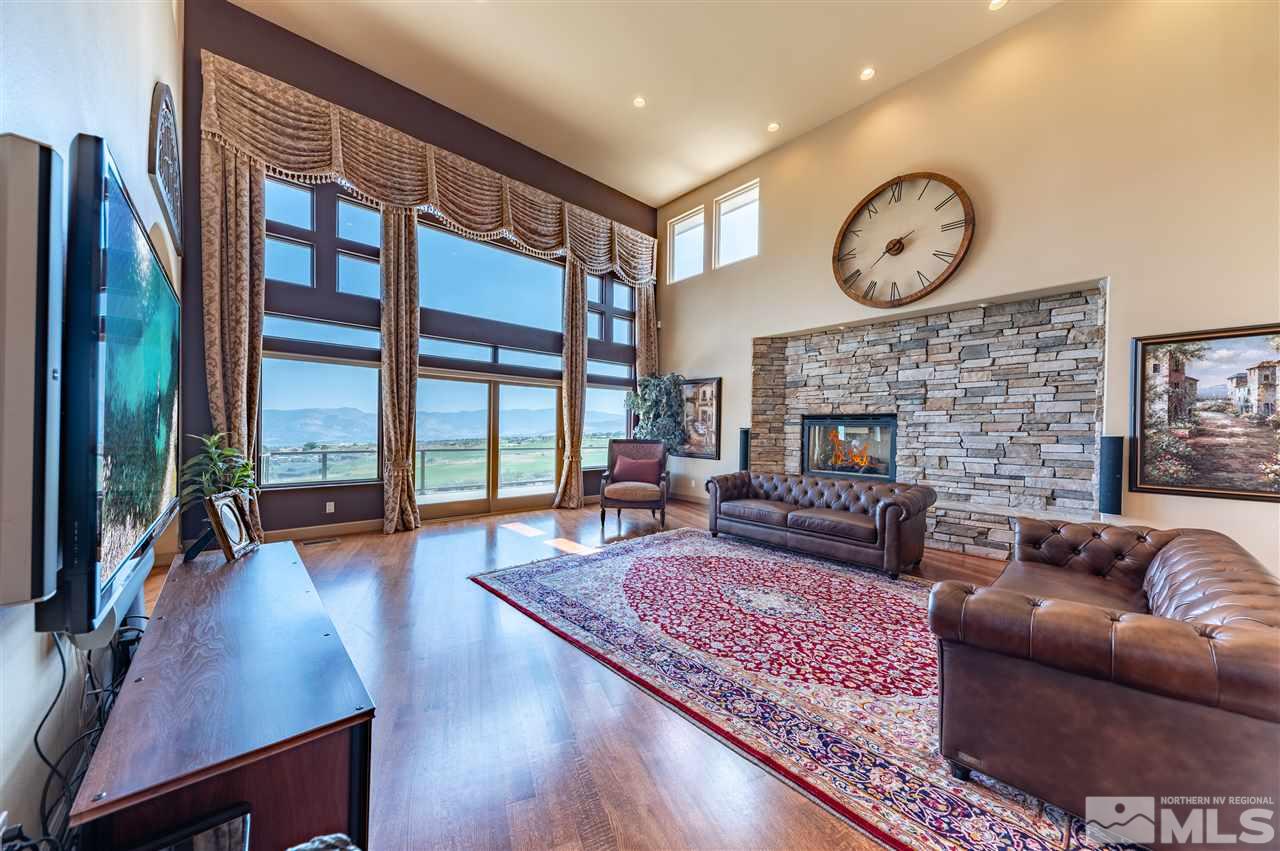 10055 Trailside Court Reno, NV 89511 - Photo 10 of 26 a living room with furniture large window and a fireplace