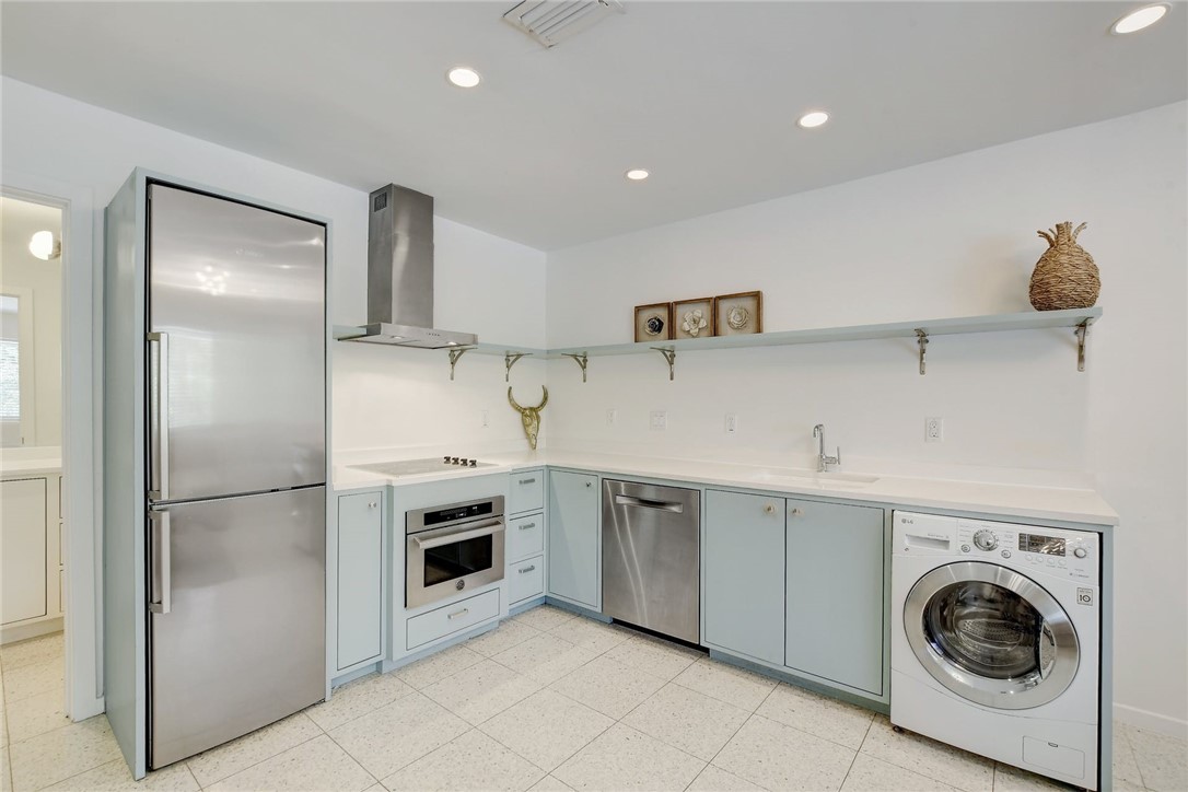 a kitchen with cabinets and stainless steel appliances