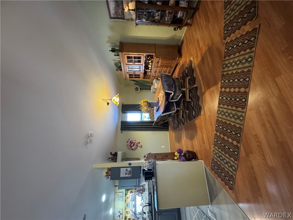 4222 Estrella Road Golden Valley, AZ 86413 - Photo 12 of 34 This open-concept living space features light wood flooring, recessed lighting, and a dining area with a chandelier