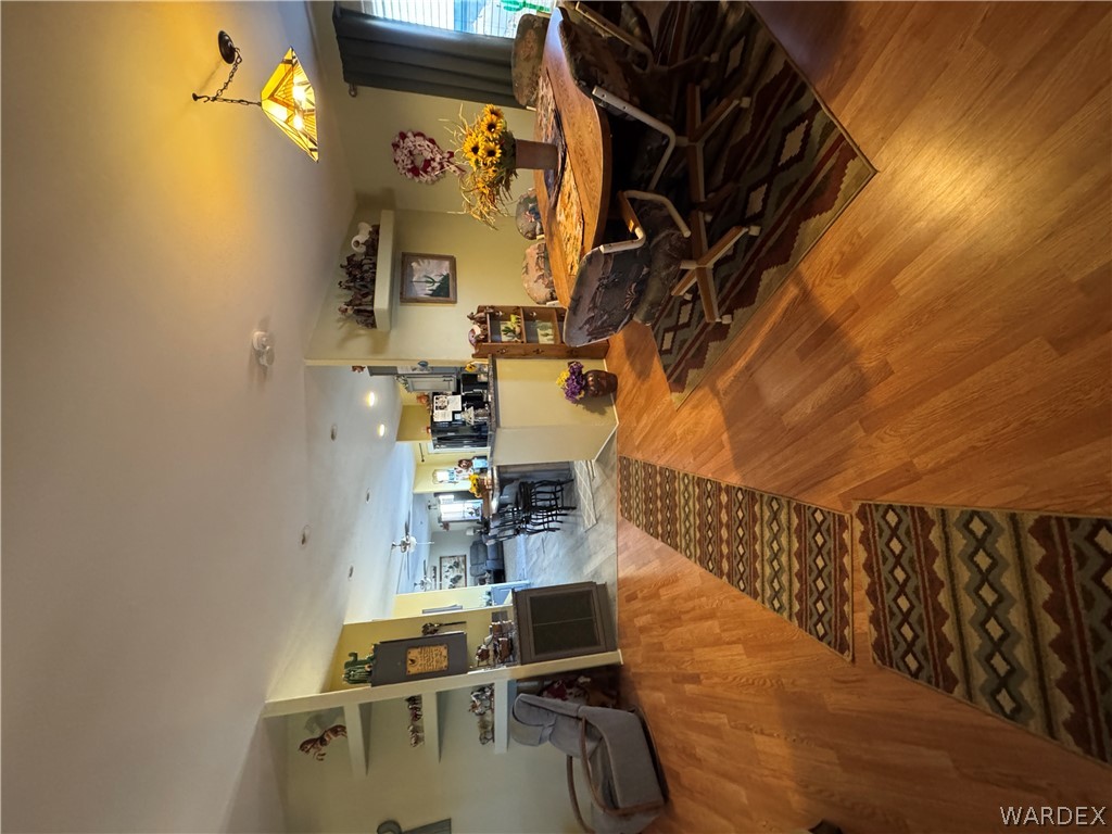 4222 Estrella Road Golden Valley, AZ 86413 - Photo 13 of 34 This interior view showcases light-colored flooring throughout, with a dining area featuring a pendant light fixture and a table