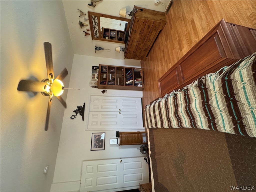 4222 Estrella Road Golden Valley, AZ 86413 - Photo 16 of 34 Bedroom featuring light wood flooring, white walls, and a ceiling fan
