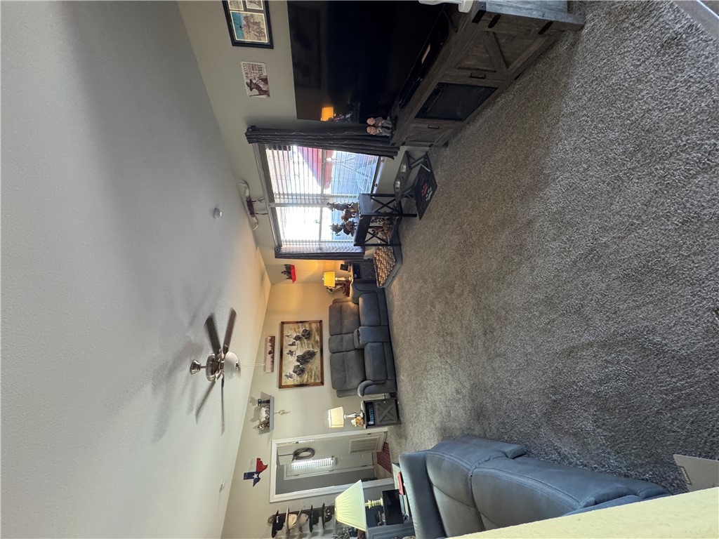 4222 Estrella Road Golden Valley, AZ 86413 - Photo 29 of 34 Spacious living area featuring carpeted flooring, a ceiling fan, and window blinds