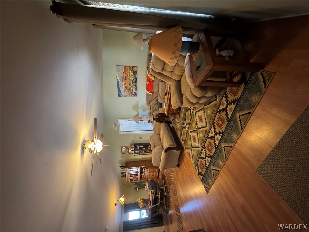 4222 Estrella Road Golden Valley, AZ 86413 - Photo 10 of 34 The living area features light-colored walls, ceiling fans, and wood flooring