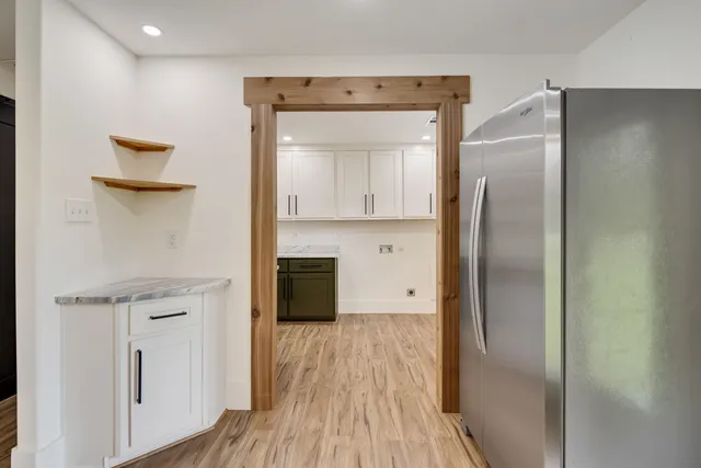a kitchen with a refrigerator and a sink