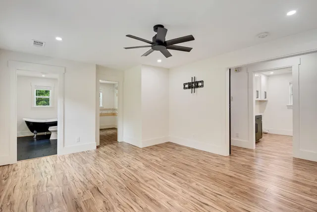a view of empty room with wooden floor