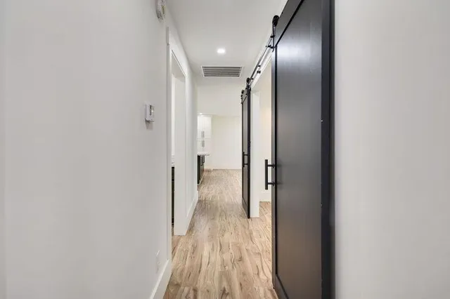 a view of hallway with wooden floor