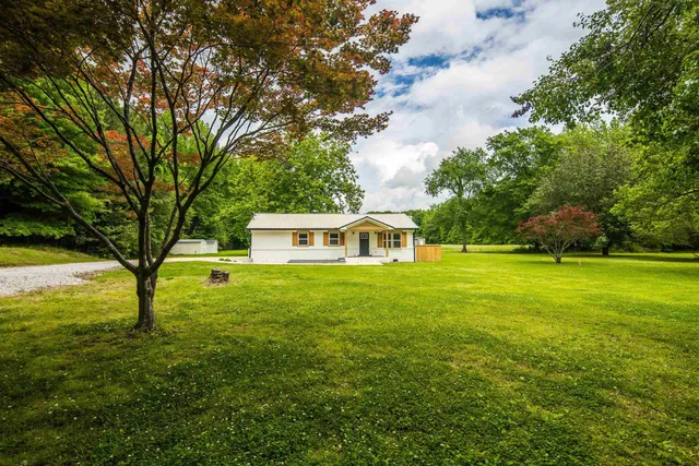 a front view of a house with a garden
