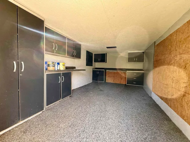 a kitchen with stainless steel appliances granite countertop a refrigerator and a stove