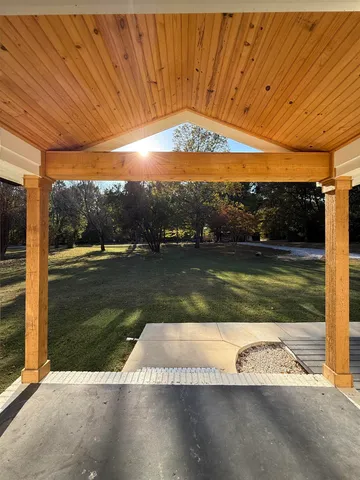 a view of a swimming pool with a yard