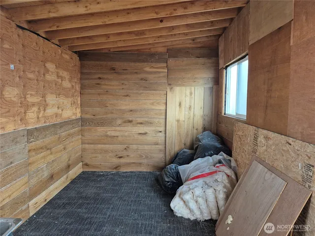 a view of a room that has a bed and a chair