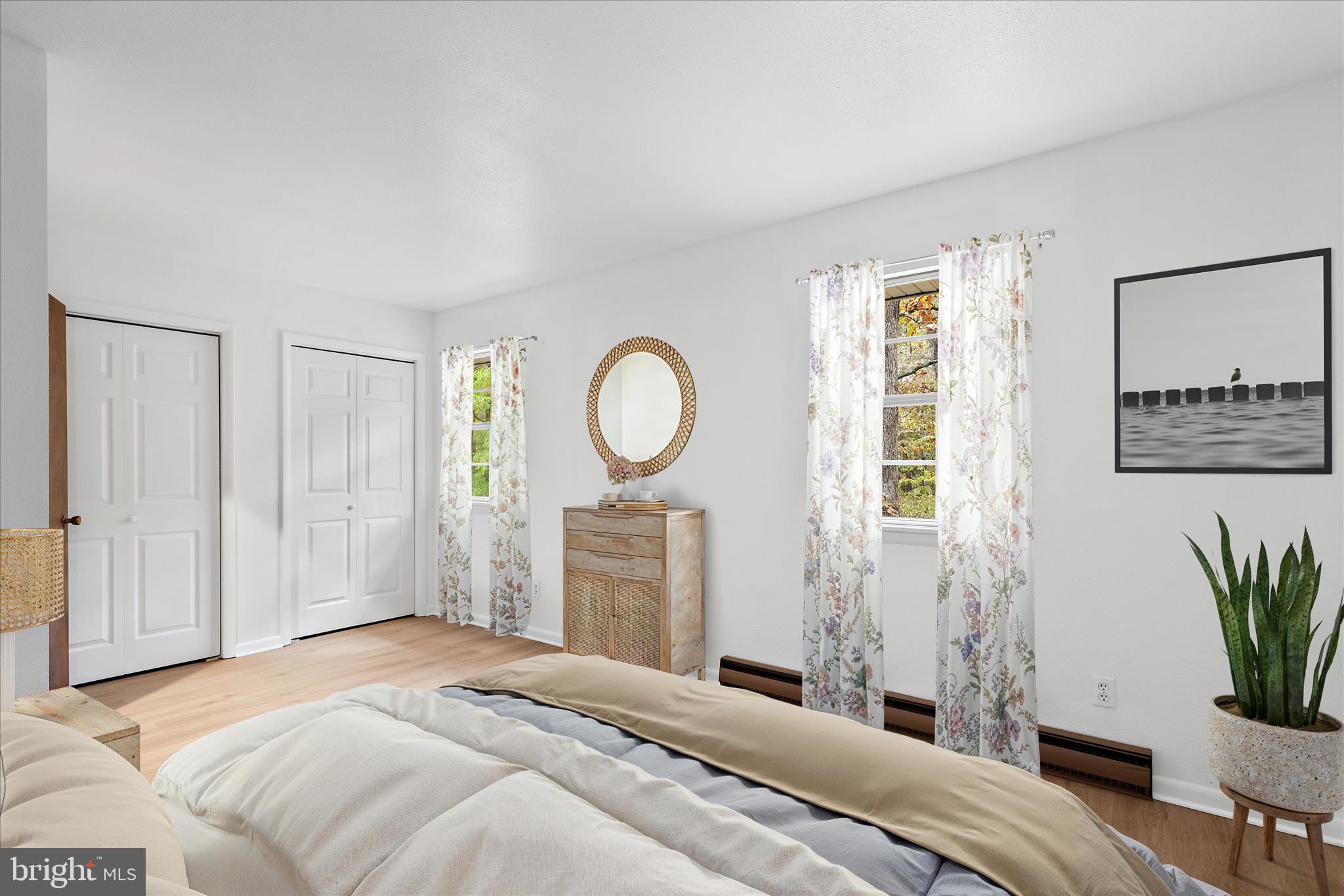 31703 Hickory Manor Road Frankford, DE 19945 - Photo 14 of 49 a bedroom with a bed and a potted plant next to a window