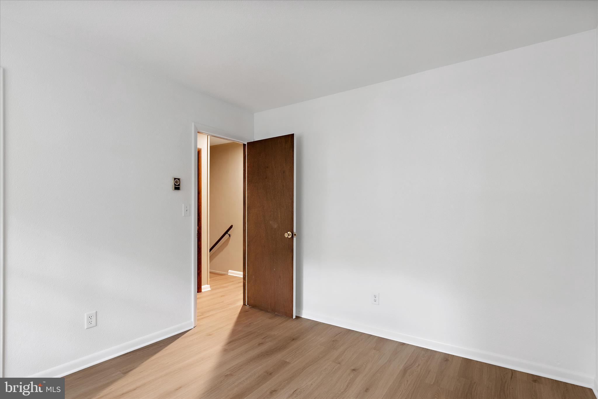 31703 Hickory Manor Road Frankford, DE 19945 - Photo 22 of 49 a view of an empty room with wooden floor and a window