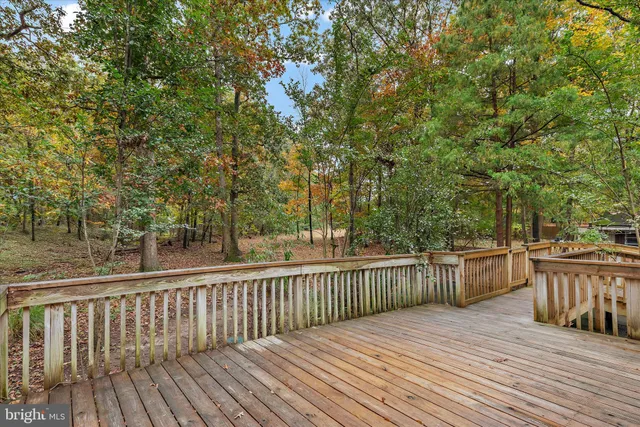a balcony with wooden floor and fence
