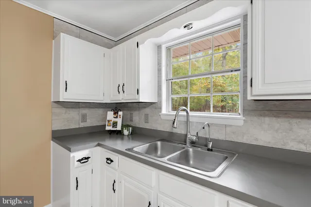 a kitchen with a sink cabinets and window