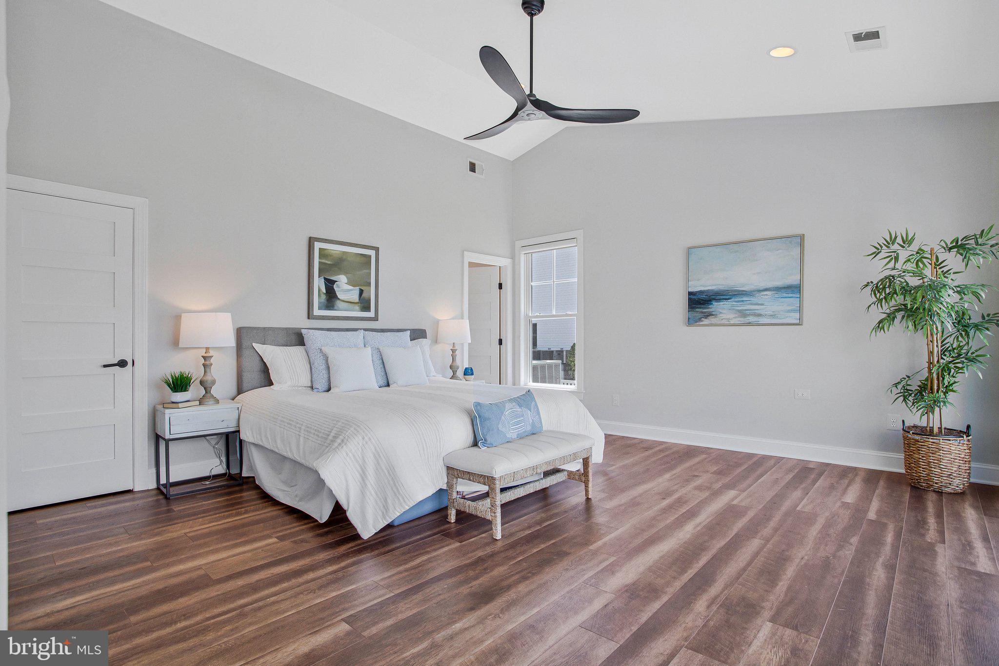 6146 Drum Point Road Deale, MD 20751 - Photo 35 of 75 a spacious bedroom with a bed and a potted plant