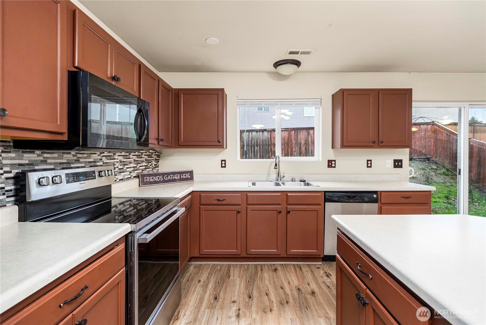 14942 99th Way Southeast Yelm, WA 98597 - Photo 15 of 37 a kitchen with stainless steel appliances a sink stove and cabinets