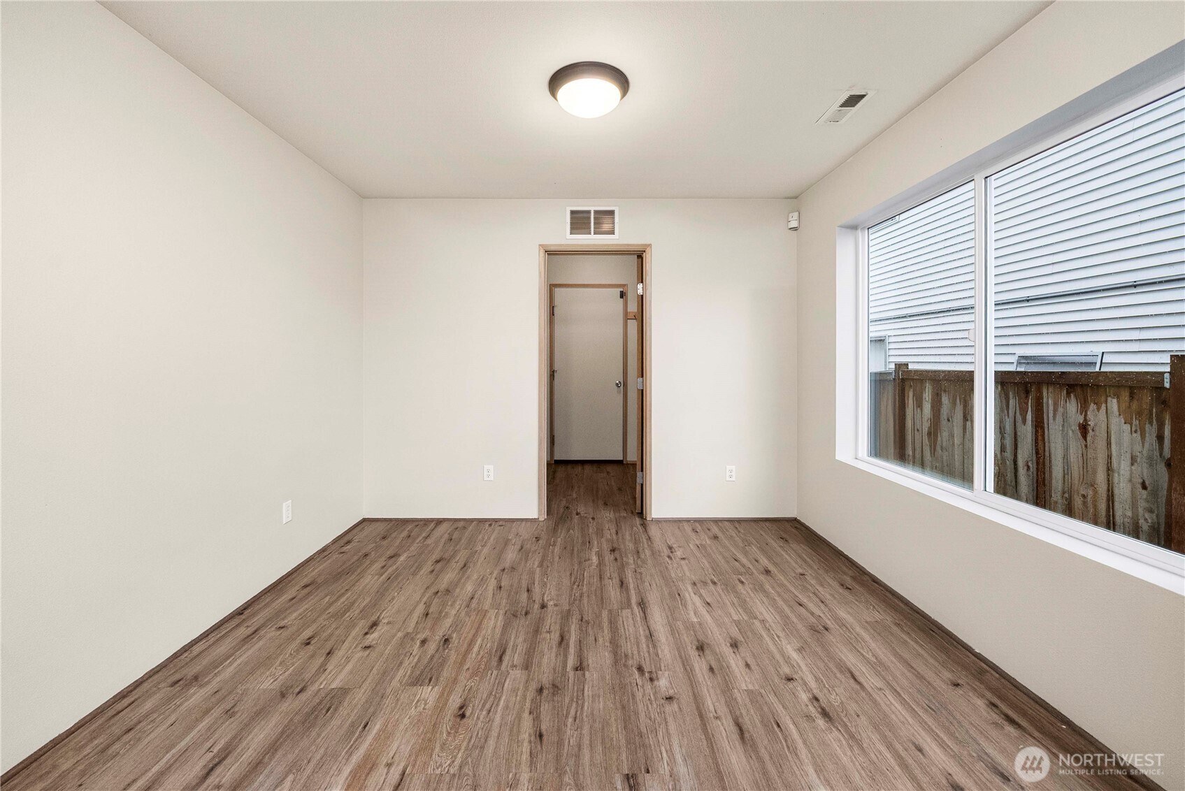 14942 99th Way Southeast Yelm, WA 98597 - Photo 17 of 37 an empty room with wooden floor and windows