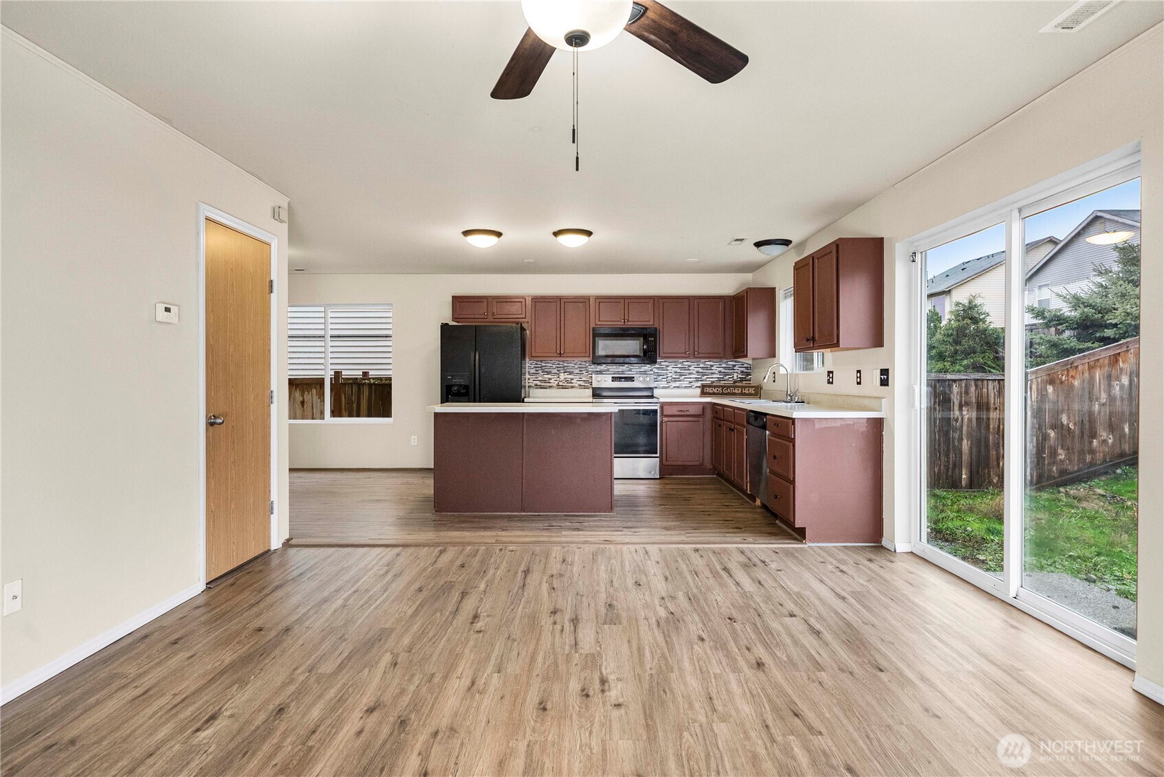 14942 99th Way Southeast Yelm, WA 98597 - Photo 8 of 37 a kitchen with stainless steel appliances granite countertop a refrigerator a stove top oven a sink dishwasher and white cabinets with wooden floor