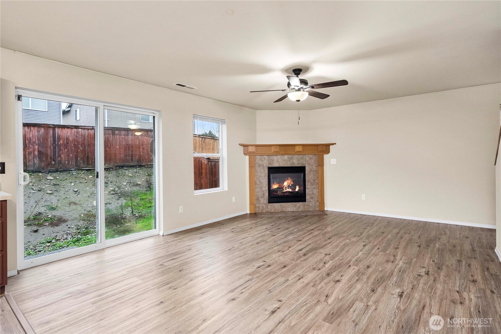 14942 99th Way Southeast Yelm, WA 98597 - Photo 9 of 37 a view of an empty room with wooden floor and a fireplace