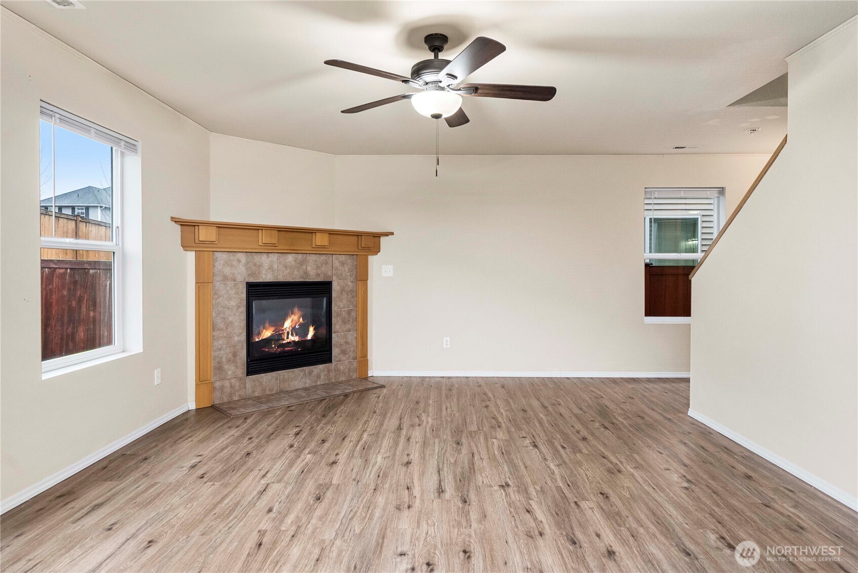 14942 99th Way Southeast Yelm, WA 98597 - Photo 10 of 37 a view of an empty room with a fireplace and a window