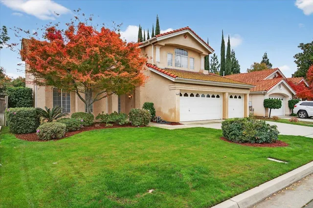 a front view of a house with a garden