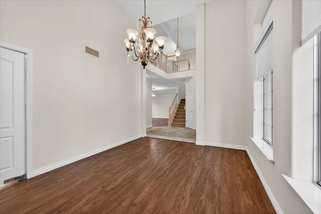 a view of a livingroom with a fireplace wooden floor and a window