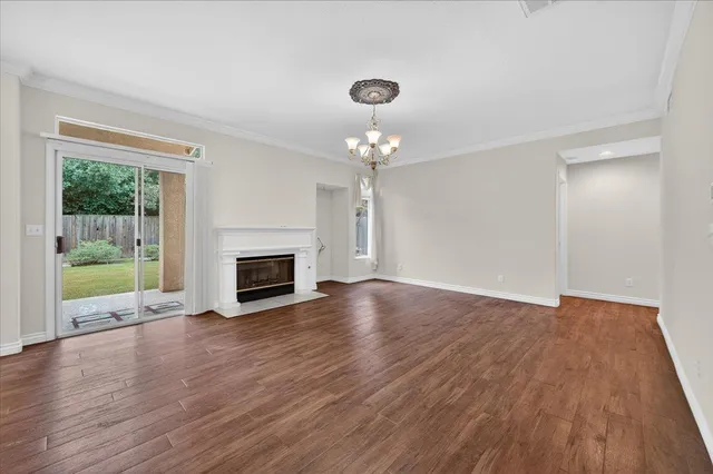a view of kitchen and hall with wooden floor