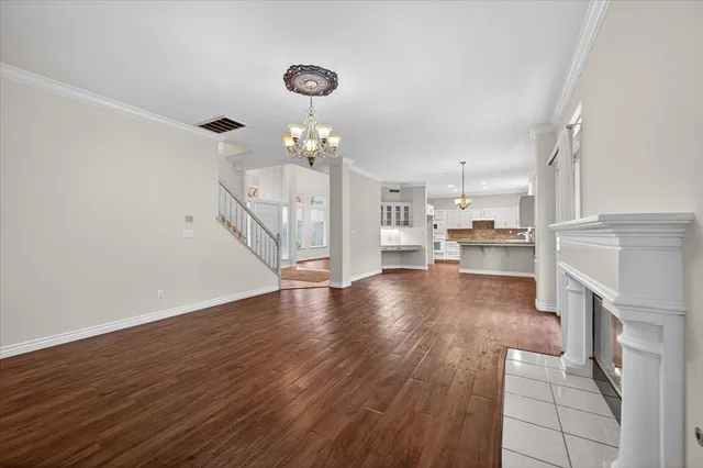a kitchen with granite countertop white cabinets white appliances a sink and a window