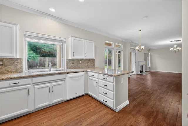 a bathroom with a sink a toilet a mirror and shower