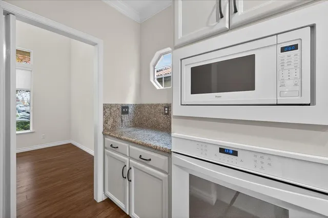 a view of a hallway with wooden floor and entryway