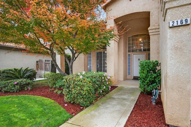 a view of a white house with a yard