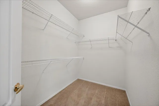 a view of a backyard with table and chairs and wooden fence