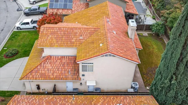 an aerial view of a house with swimming pool and porch