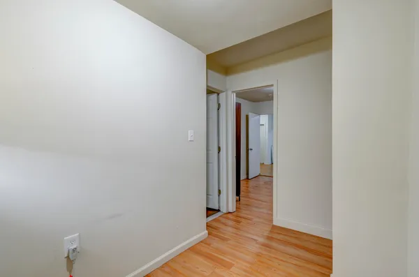 a view of a hallway with wooden floor