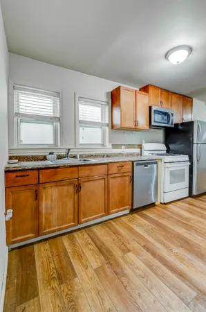 a kitchen with a sink cabinets and window