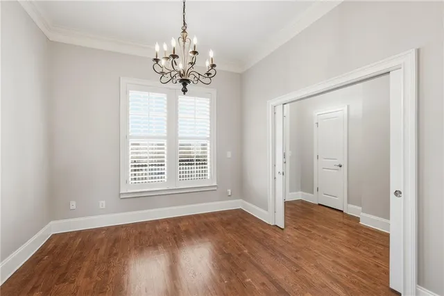 a kitchen with stainless steel appliances granite countertop a refrigerator a stove a sink and a wooden floor