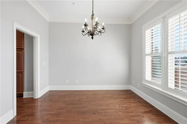 a kitchen with stainless steel appliances granite countertop a sink a stove a refrigerator and island with wooden floor