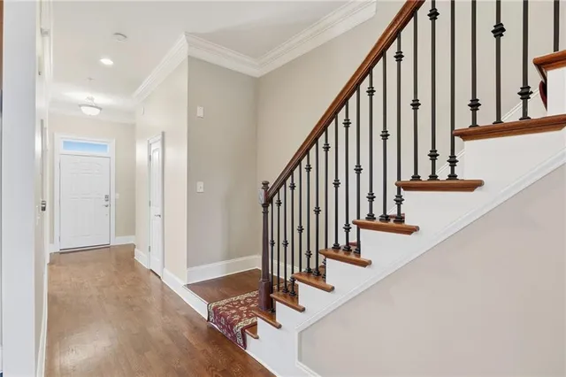 a view of a kitchen with a refrigerator a sink and wooden floor