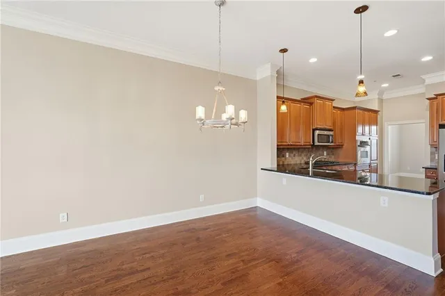 a view of a livingroom with wooden floor a fireplace and windows