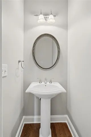 a view of a room with wooden floor and a fireplace