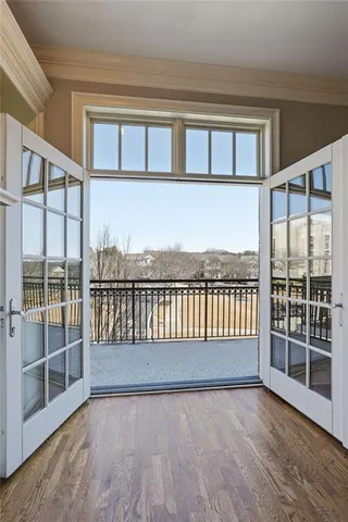 an empty room with ceiling fan and window