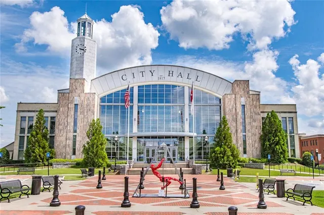 a view of a swimming pool with a patio and a garden