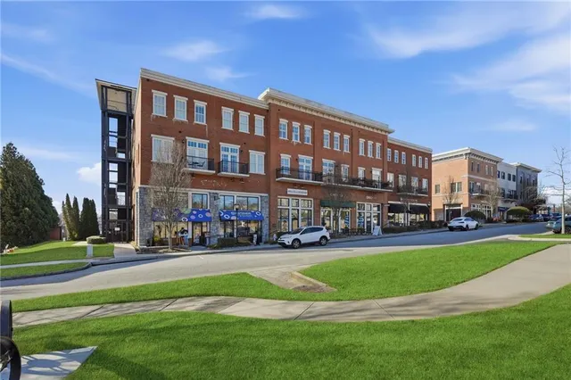 a view of a hallway with wooden floor and closet area