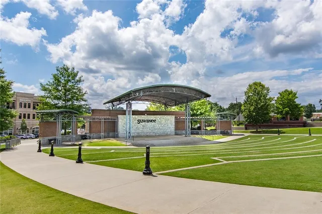 a view of pool with large trees and a big yard