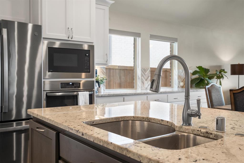 1647 Twistleaf Road Northlake, TX 76226 - Photo 13 of 39 a kitchen with a sink cabinets and stainless steel appliances