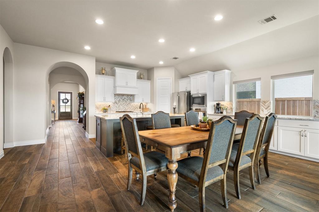 1647 Twistleaf Road Northlake, TX 76226 - Photo 16 of 39 a large kitchen with dining table chairs and wooden floor