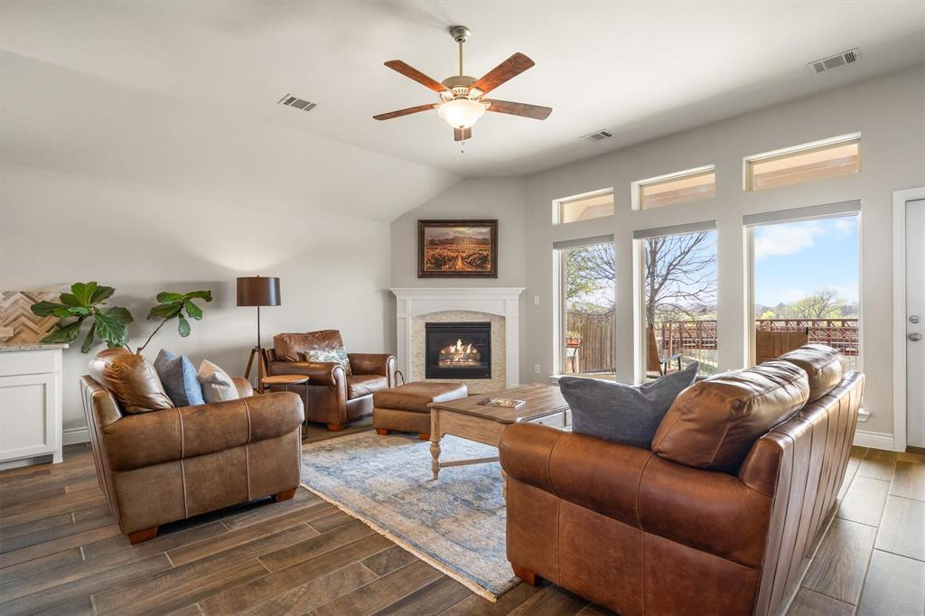1647 Twistleaf Road Northlake, TX 76226 - Photo 17 of 39 a living room with furniture a large window and a fireplace